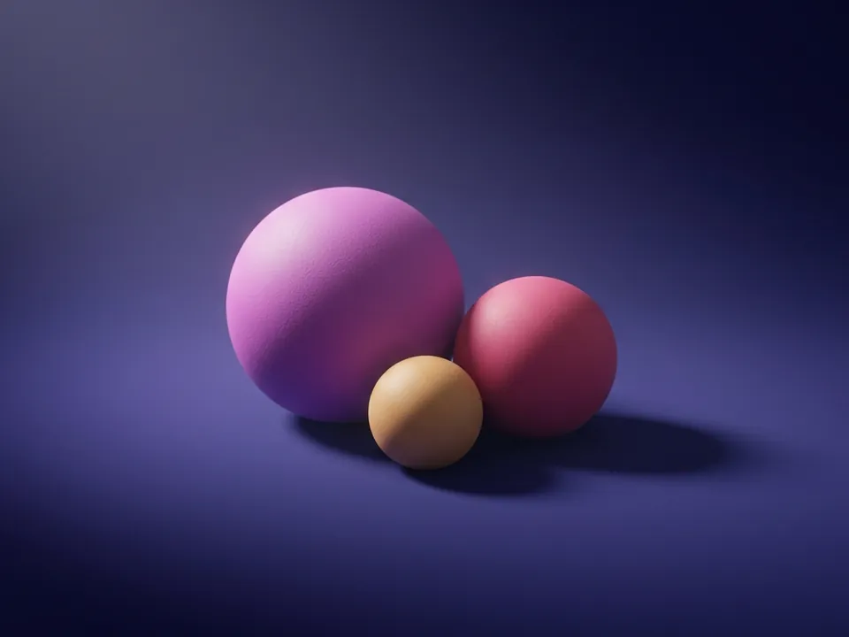 Tres esferas de cerámica mate en tonos magenta, rosa y ámbar, apoyadas juntas en equilibrio.